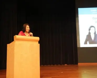 Dr Dora Hoan speaking on podium talking to DSAS meeting