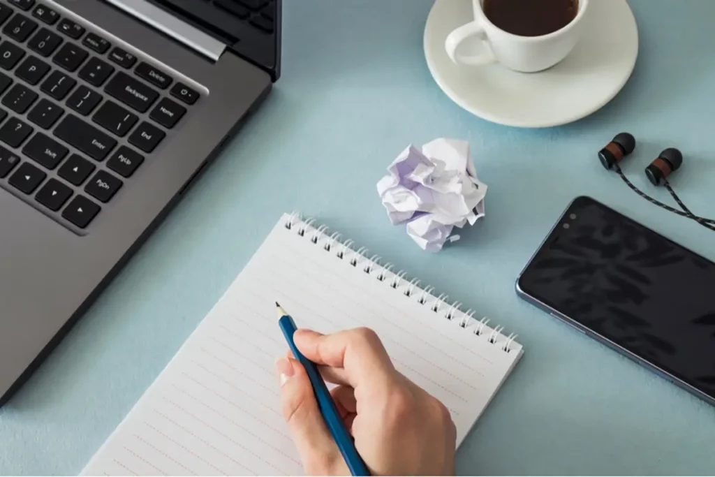 Writing down new year's resolutions for direct sellers and business success over coffee 