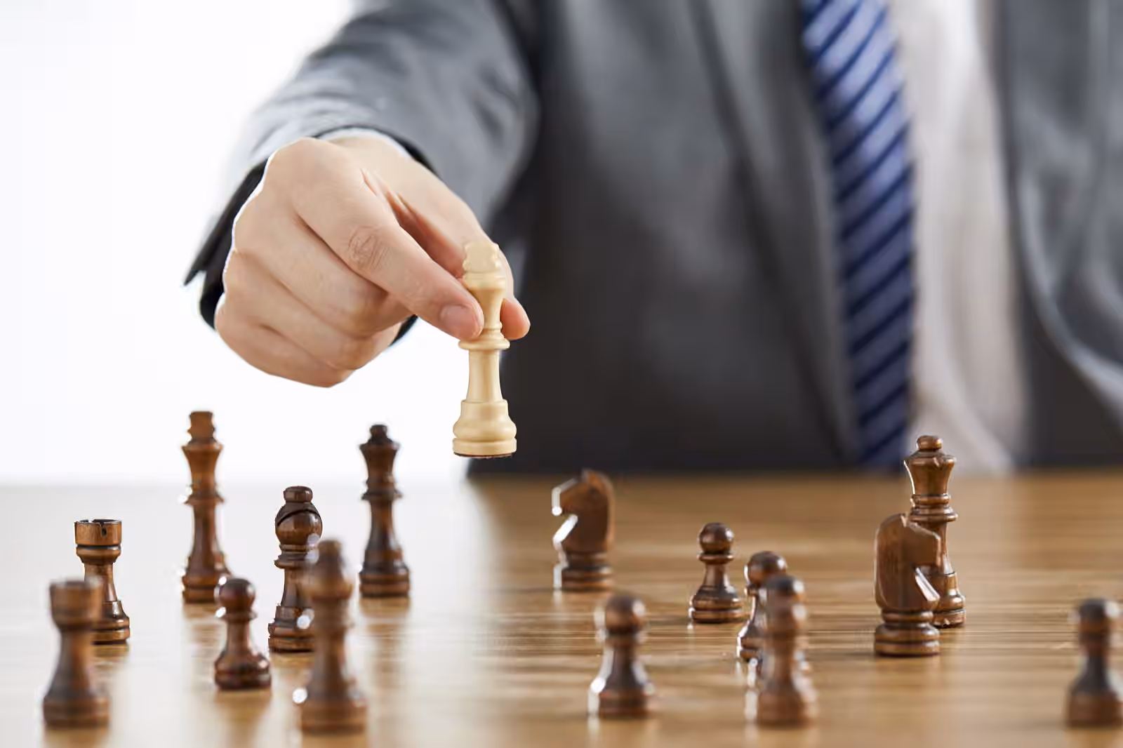 What Type Of Entrepreneur Are You? 2 A businessman in a suit playing chess and about to win, reflecting what type of entrepreneur are you