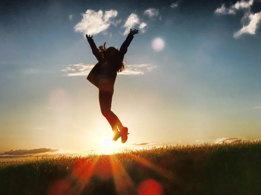 Silhouette of a person jumping over a horizon, signifying their joy at achieving more business success by developing more future-ready skills