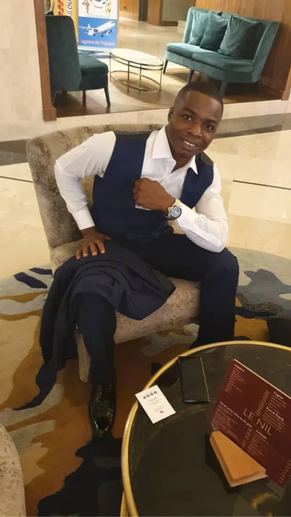Houffoue Yao Hyacinthe sitting in a hotel lobby at event