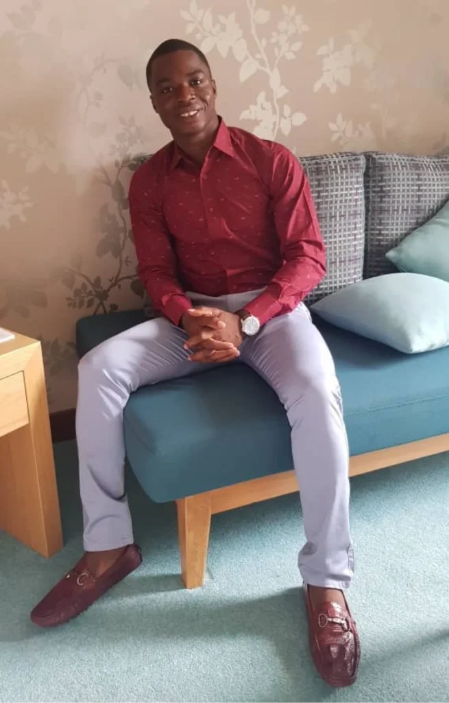 Houffoue Yao Hyacinthe sitting on a couch