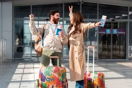 Couple excited to escape winter season by going on a budget-friendly package holiday, which they booked through a QVI holiday membership product called QVI Vacay