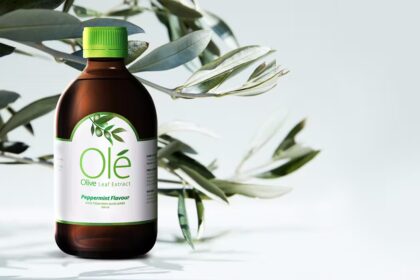 Bottle of Ole Olive Leaf Extract in front of olive leaves