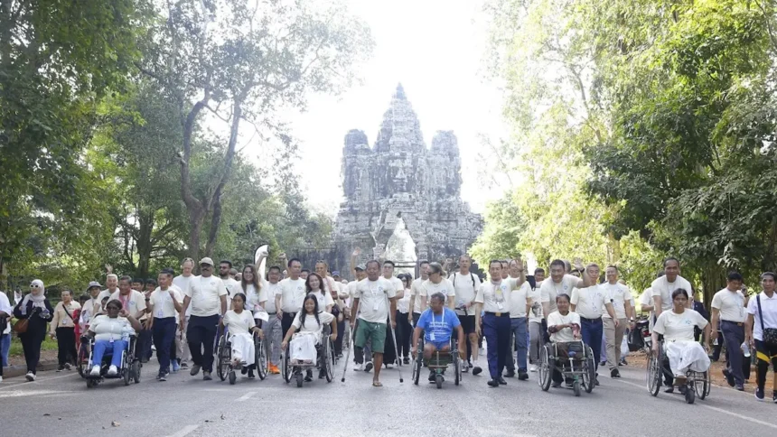 Participants in the march for a mine-free Cambodia sponsored by QNET, in front of Angkor Wat