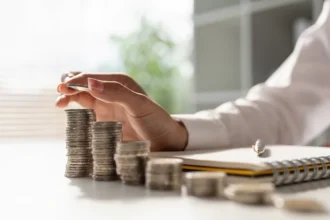 image of hand counting stacks of coins
