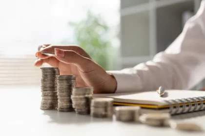 image of hand counting stacks of coins
