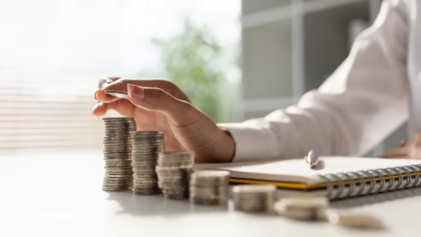 image of hand counting stacks of coins