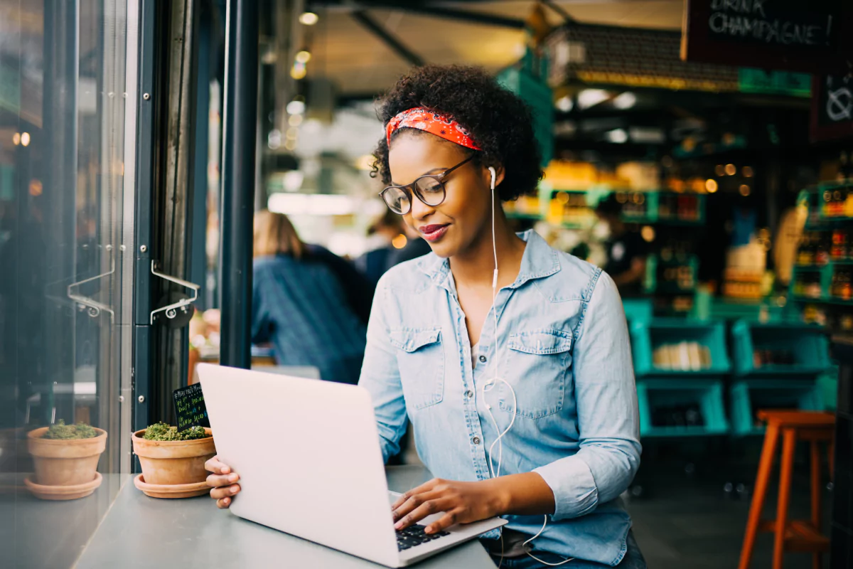 Can direct selling be a long-term career? Woman sits at a cafe while working on her computer