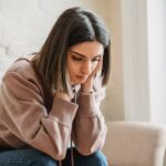 Sad woman wondering is the middle class the new poor?